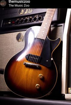 an electric guitar sitting on top of a amplifier