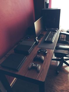 a laptop computer sitting on top of a wooden desk next to a keyboard and mouse