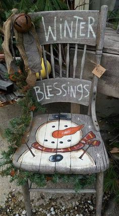 a wooden chair with a snowman painted on it's back and the words winter blessing