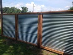 a wooden fence with metal slats on it