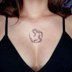 a woman's chest with a tattoo design on the top and bottom part of her breast