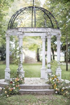 an instagram page with flowers on the ground and a gazebo in the background