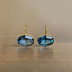 Deep blue hues and flashing facets are framed by rich yellow gold in this head-turning pair. 

18k yellow gold 
London blue topaz, 17mm x 13mm (5/8" x 1/2") 
Earrings hang 7/8" from the ear 
Each earring weighs 3.5g Luxury Octagon Earrings For Formal Occasions, Luxury Blue Topaz Brilliant Cut Earrings, Luxury Blue Topaz Jewelry With Matching Earrings, Luxury Multi-stone Blue Topaz Earrings, Luxury Modern Blue Topaz Earrings, Luxury Faceted Topaz Jewelry, Luxury Blue Cabochon Earrings, Luxury Octagon Topaz Jewelry, Luxury Blue Topaz Dangle Earrings