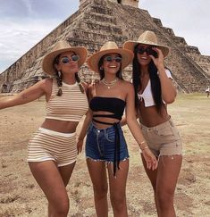 three young women posing in front of an ancient pyramid at chichena, mexico