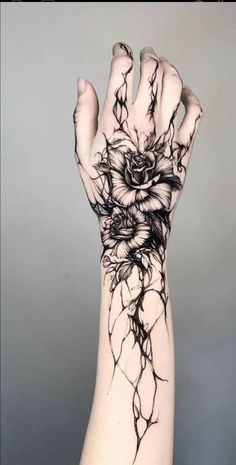 a person's arm with black ink on it, and an image of a flower in