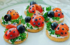 small sandwiches with ladybugs and lettuce on them sitting on a plate