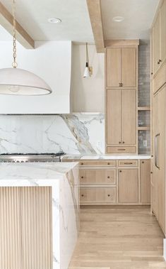 a kitchen with marble counter tops and wooden cabinets