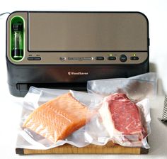 two fish fillets in plastic bags next to an electric meat slicer and knife