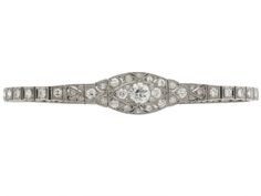 Art Deco Diamond Bracelet in Platinum   Wreath your wrist in tremendous twinkling with this delectable diamond bracelet from the Art Deco era! Platinum forms a sleek single row line bracelet with a wider, rounded central motif featuring scintillating diamonds within a marquise-shaped setting. Luxury Marquise Cut Diamond Bracelet For Formal Events, Luxury Marquise Cut Diamond Bracelet For Formal Occasions, Classic Marquise White Gold Diamond Bracelet, Classic Marquise Diamond Bracelet In White Gold, Luxury Diamond Bracelet With Marquise Cut, Luxury Marquise Cut Diamond Bracelet For Anniversary, Classic Silver Marquise Diamond Bracelet, Classic Marquise Diamond Bracelet With Brilliant Cut, Marquise Diamond Cut Diamond Bracelet