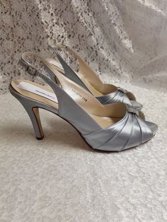 "Beautiful silver heels, sample sale, they been worn for a short time to take pictures, the outer sole has walk on marks but, other than that shoes are in perfect condition! Price reflects comment above. Thank you! Only one pairs Size: 10 Heel: 3 1/4\" Inside length: 10 5/8\" PLEASE MEASURE YOUR FEET LENGTH TO ENSURE FIT. FINAL SALE, NO RETURNS, NO EXCHANGES, NO EXCEPTIONS. PLEASE CONTACT FOR ANY ADDITIONAL QUESTIONS OR, CONCERNS. THANK YOU!" Metallic Silver Heels With 4-inch Heel For Formal Occasions, Silver Heels With Padded Heel And Round Toe, Silver Closed Toe Heels With Padded Heel, Silver Heels With Round Toe Medium Width, Silver Open Toe Heels For Formal Occasions, Silver High Heel Shoes With Medium Width, Silver High Heel Heels Medium Width, Silver Low Heel Medium Width Heels, Silver High Heels With Medium Width