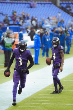 two football players are running on the field