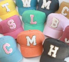 many different colored hats with sequins and the letters j, m, l, person