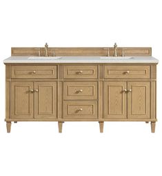 a bathroom vanity with double sinks and two faucets on the top, all in light wood