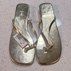 Brand New, Never Worn Light Gold Size 8 Thong/Flip Flop Sandals. Slight 1/4 Inch Wedge. Man Made Materials. Offering Free Shipping On These. Price As Listed Is The Lowest Price I Can Go Considering Poshmark Takes A Fee. Trendy Gold Flip Flops For Summer, Summer Toe Loop Synthetic Flip Flops, Trendy Gold Synthetic Flip Flops, Gold Trendy Synthetic Flip Flops, Gold Flip Flops For Beach In Spring, Spring Synthetic Gold Flip Flops, Spring Gold Synthetic Flip Flops, Gold Synthetic Summer Flip Flops, Sparkly Sandals