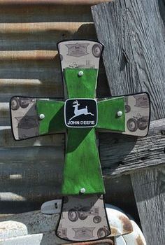 a green and black cross sitting on top of a wooden bench