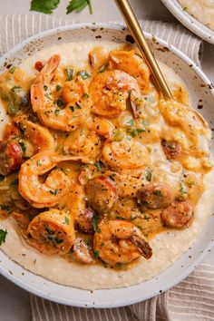 a bowl filled with shrimp and grits on top of a table