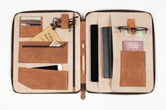 an open leather case with various items in it