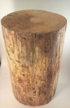 a wooden stump sitting on top of a white table