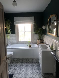 a bathroom with black walls and white fixtures