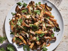 a white plate topped with mushrooms and parsley