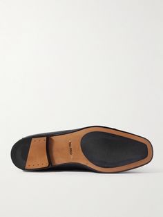 Tom Ford reimagines its 'Sean' loafers with twisted penny bars. They're made from full-grain leather with a sharp square toe and durable rubber soles. Wear with everything from tailored trousers to casual jeans. Business Dress Shoes With Leather Sole And Square Toe, Leather Square Toe Dress Shoes For Business, Square Toe Leather Dress Shoes For Business, Calf Leather Moc Toe Dress Shoes With Textured Sole, Square Toe Leather Shoes For Business Casual, Business Leather Shoes With Branded Insole And Square Toe, Business Loafers With Square Toe And Rubber Sole, Square Toe Calf Leather Loafers With Branded Insole, Business Loafers With Textured Sole And Square Toe