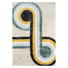 a white rug with blue, yellow and black circles on it's edges in the shape of a letter p