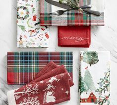 four christmas napkins on top of each other with scissors and utensils next to them