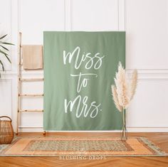 a sign that says, miss to mrs on it in front of a chair and potted plant