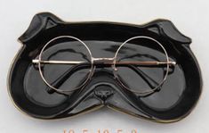 a pair of glasses sitting on top of a black plate