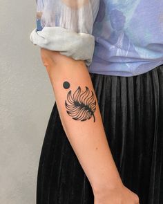 a woman with a black and white tattoo on her arm