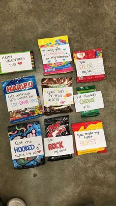 many candy bars are laid out on the floor with some writing on them, and one is