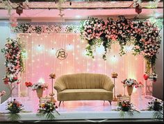 a couch sitting on top of a stage covered in flowers