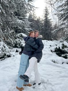 two people are hugging in the snow