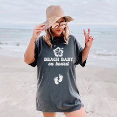 Introducing our "Beach Baby on Board" Comfort Colors shirt, perfect for your summer pregnancy announcement by the sea. Whether it's a cruise or beach vacation, share your joy in style. Ideal for baby showers or gender reveals, its soft fabric ensures comfort while flaunting your bump. Soft-washed Summer Beach T-shirt, Family Matching T-shirt For Beach Season Vacation, Family Matching T-shirt For Beach Vacation, Summer T-shirt For Family Vacation At The Beach, Summer Beach T-shirt For Family Vacation, Family Matching Tops For Beach In Summer, Family Matching Tops For Vacation In Summer, Summer Tops For Family Beach Vacation, Summer Tops For Family Vacation Beach Season