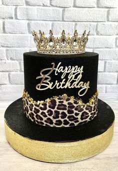 a black and gold leopard print birthday cake with a crown on top that says happy birthday