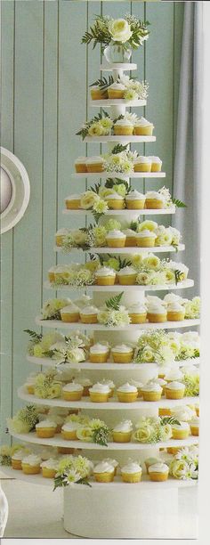 cupcakes are stacked on top of each other in the shape of a tree