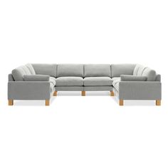 a large sectional couch with wooden legs and grey upholstered fabric, on a white background