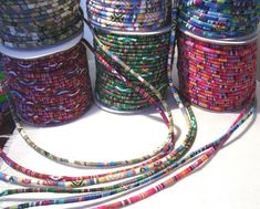 several spools of multicolored bead on a table