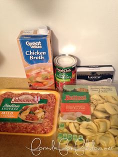 some food items are sitting on a counter top next to a box of chicken broth