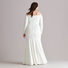 a woman in a long white dress is looking back