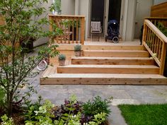 a wooden porch with steps leading up to the front door