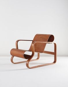 a wooden chair sitting on top of a white floor