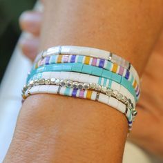 Our MAUI stack includes SIX Total bracelets! (Yes, 6 Included in the stack are 5 tila bracelets with bright colors of mustard, turquoise, white, silver and two different tones of purple. The sixth bracelets is cute cube bracelet which is only comes in one size (which should fit most people)  View All Bracelet Stacks : https://etsy.me/4abyDdo Our tila bead bracelets are known for how well they stretch. They do not hug your wrist, yet they stay perfectly in place. The glass tila beads used in the Tila Bead Bracelets, Cube Bracelet, Tila Bracelets, Tila Bracelet, Bracelet Stacks, Tila Beads, Twisted Bracelet, Paracord Bracelets, Bead Bracelets