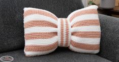 a crocheted bow tie sitting on top of a couch