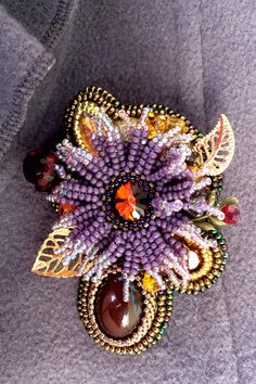 "Valentines Day Gift Brooch aster it is embroidered brooch from Japanese beads with natural stone Agate, Amber, Garnet and crystal. Flower brooch has a size 2.6*1.8 inches (6.5*4.5 cm). Video of this item you can see here https://youtu.be/-URZZ432lr0 Bright, warm flower in the frame of many natural stones and crystals. This is an autumn jewelry, which is perfect as a wedding brooch or brooch for coat This luxury brooch will perfectly complement your unique flower jewelry collection, will be a wo Unique Handmade Flower Brooches, Unique Handmade Flower Brooch, Unique Flower Brooches For Jewelry Making, Jewelry Valentines Day, Autumn Jewelry, Spider Jewelry, Embroidered Brooch, Japanese Beads, Toho Beads