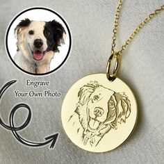 a dog's face is engraved on a gold plated necklace with an arrow