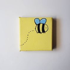 a painting of a bee flying through the air on a yellow canvas with black dots