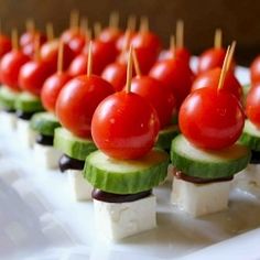 small appetizers with tomatoes and cucumbers on skewered toothpicks