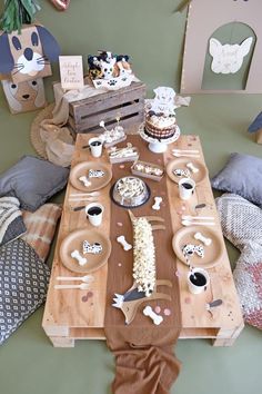 a wooden table topped with plates and bowls filled with food next to other items on top of it