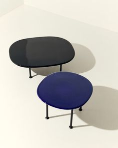 two black and blue tables sitting on top of each other